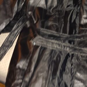 Large long leather jacket with tie around waist.
